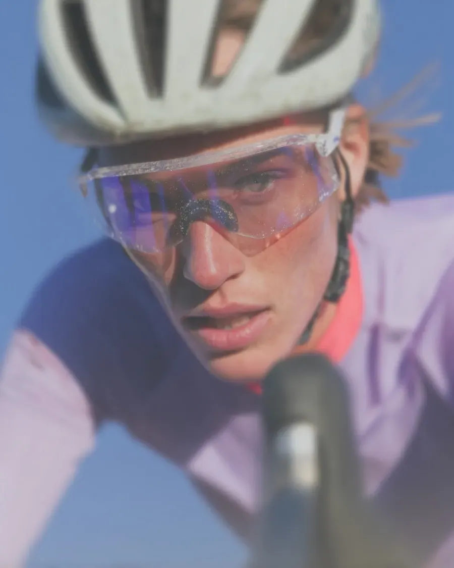 A cyclist grinning at the camera after a race