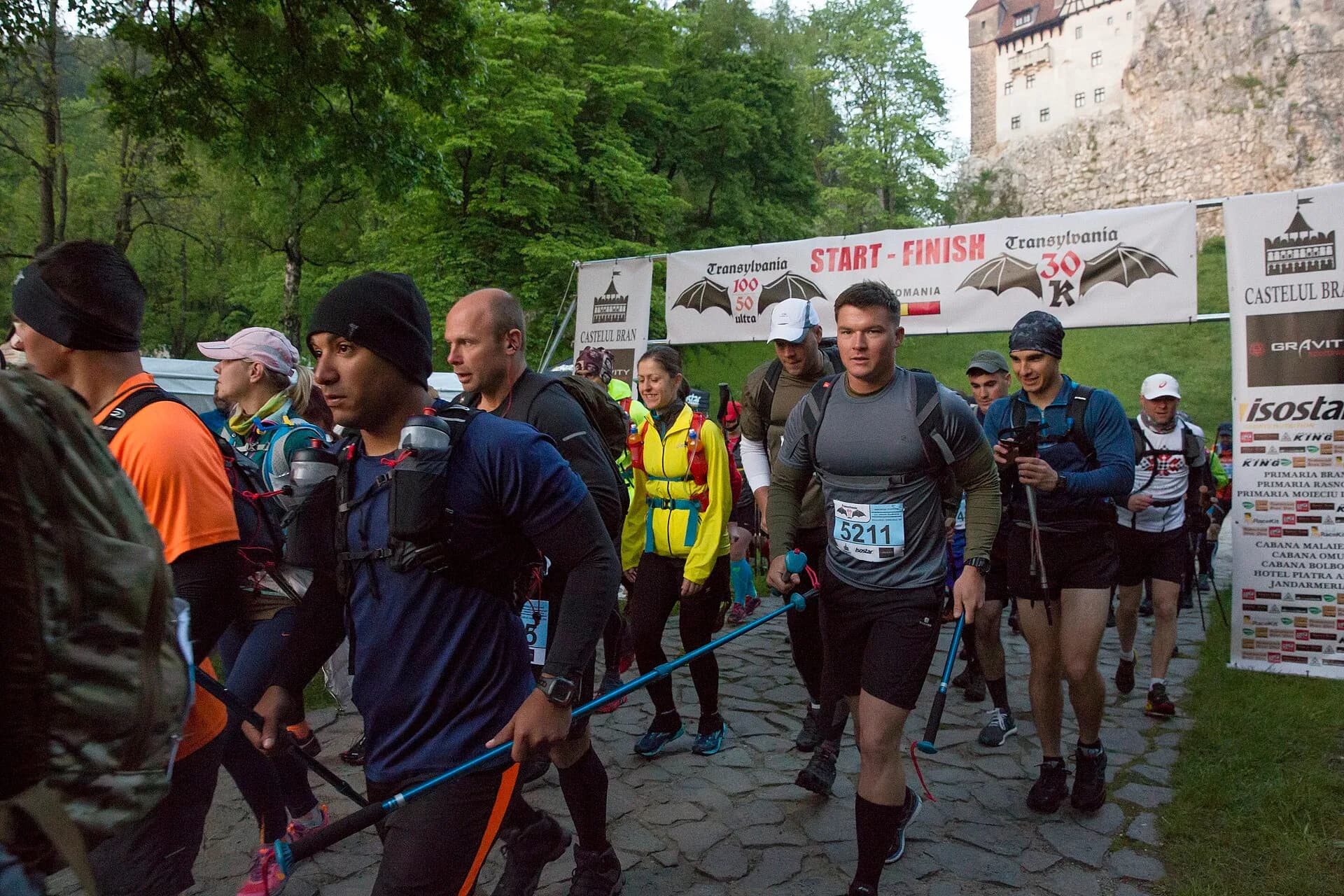 Runners strung along a mountain trail mid-race